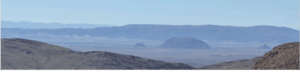 Andean panorama showing plain valley surrounded by sharp mountains
