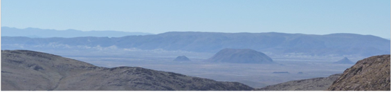 Andean panorama showing plain valley surrounded by sharp mountains